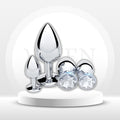 Set of polished chrome anal plugs with clear gem-like tips, four-piece training set