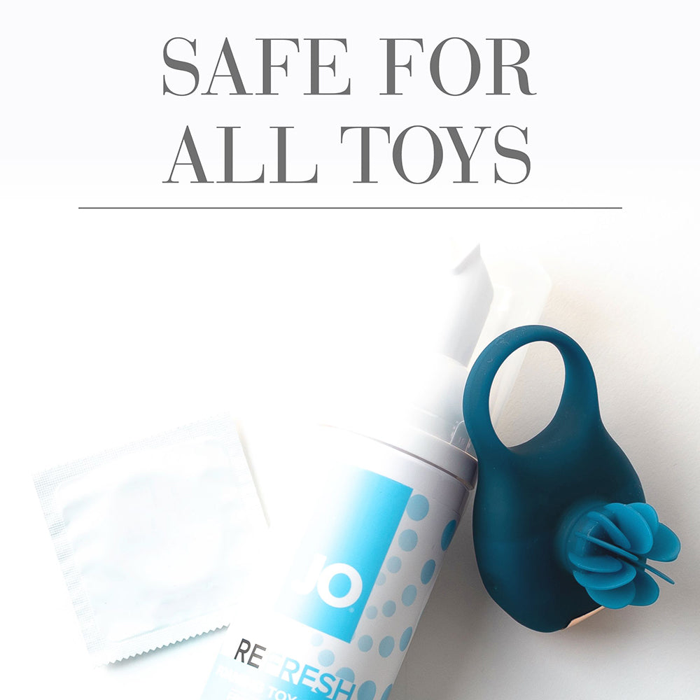 Foaming toy cleaner spray bottle with teal cleaning mitt and white wipes.