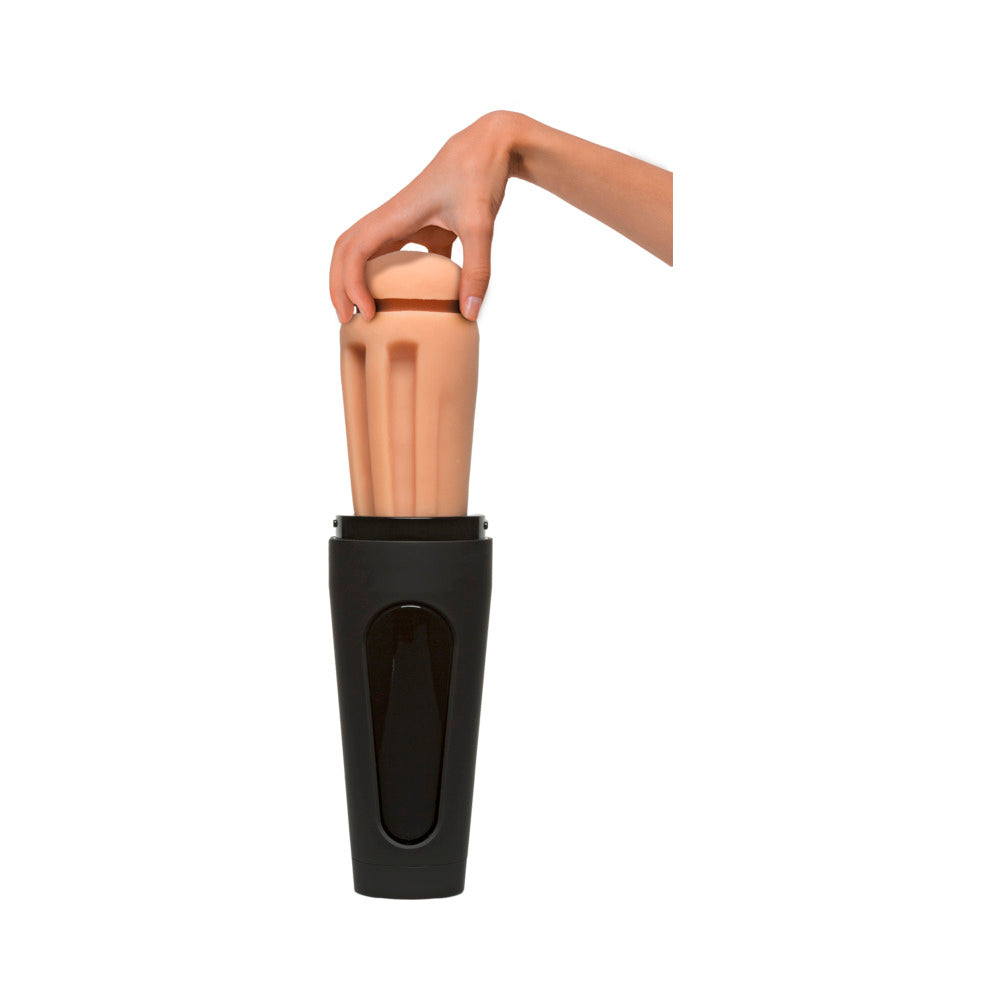 Hand holding a tan inner sleeve inserted into a black handheld device